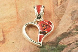 Beautiful Heart Pendant featuring Genuine Spiny Oyster Shell And Black Jade inlaid between ribbons of Sterling Silver. Accented with Fire and Ice Lab Opals. Free 18" Sterling Silver Chain with Purchase of Pendant. Designed by Navajo Artist Calvin Begay. Signed by the artist.